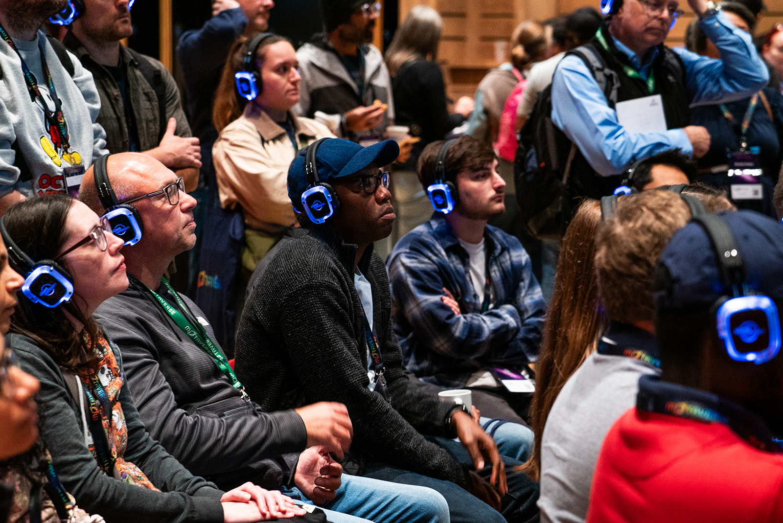 A full crowd listening in to Postman learnings with headphones on.