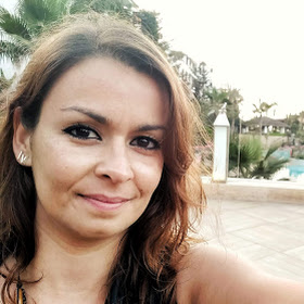 Selfie picture with a white female with light brown wavy hair and dark brown eyes.