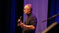 Simon Long takes to the 99 second stage at MoTaCon 25. image