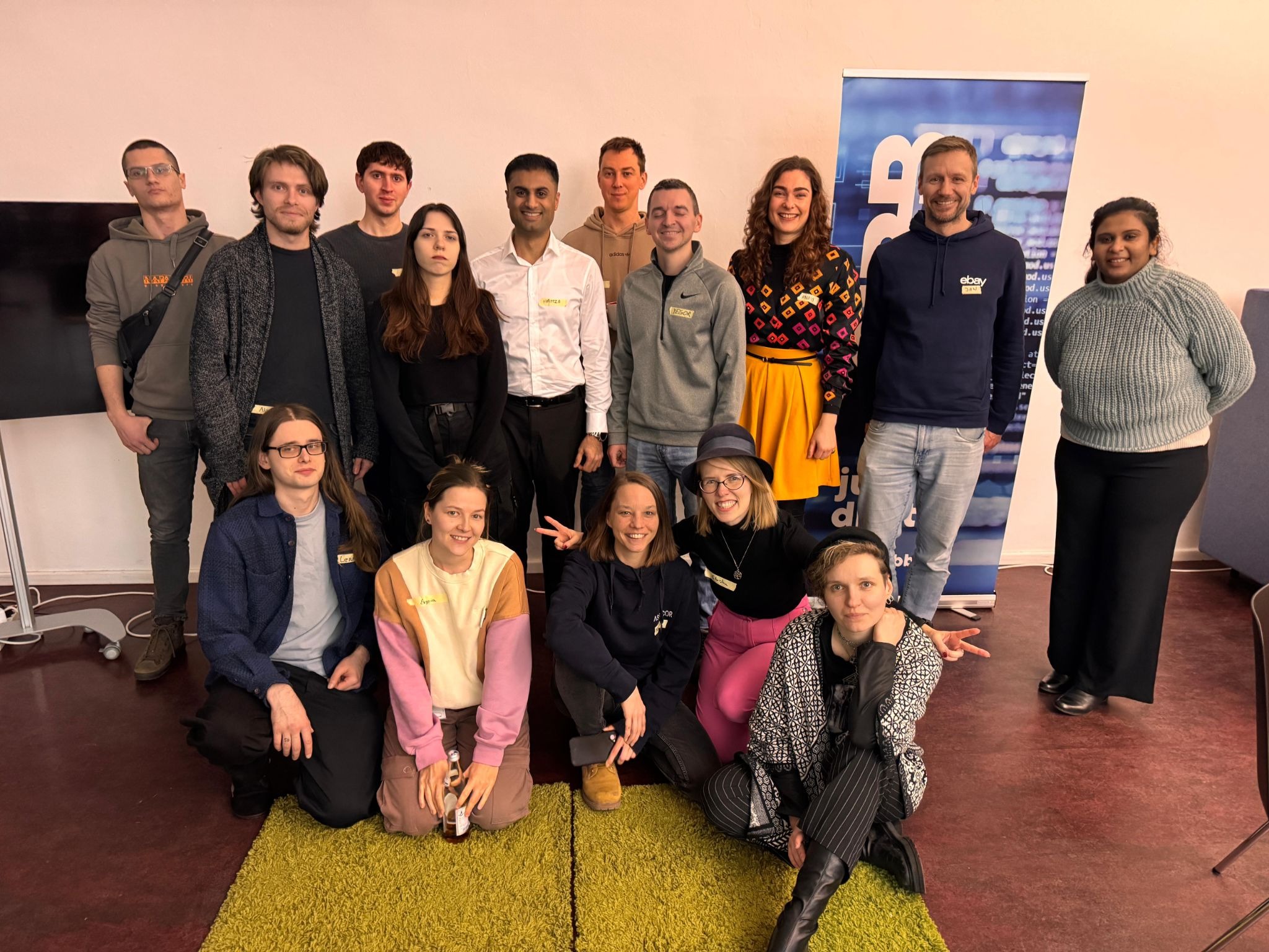 The Ministry of Testing Berlin group poses together after a Testionary session, with 15 attendees smiling in two rows.