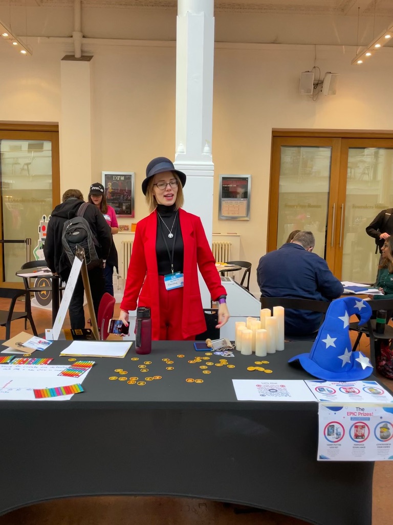 Christine Pinto wearing her red uniform standing behind a table