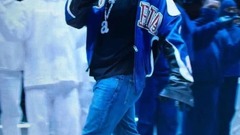 An image of Kendrick Lamar smiling at the camera, walking on stage during Superbowl 59 image