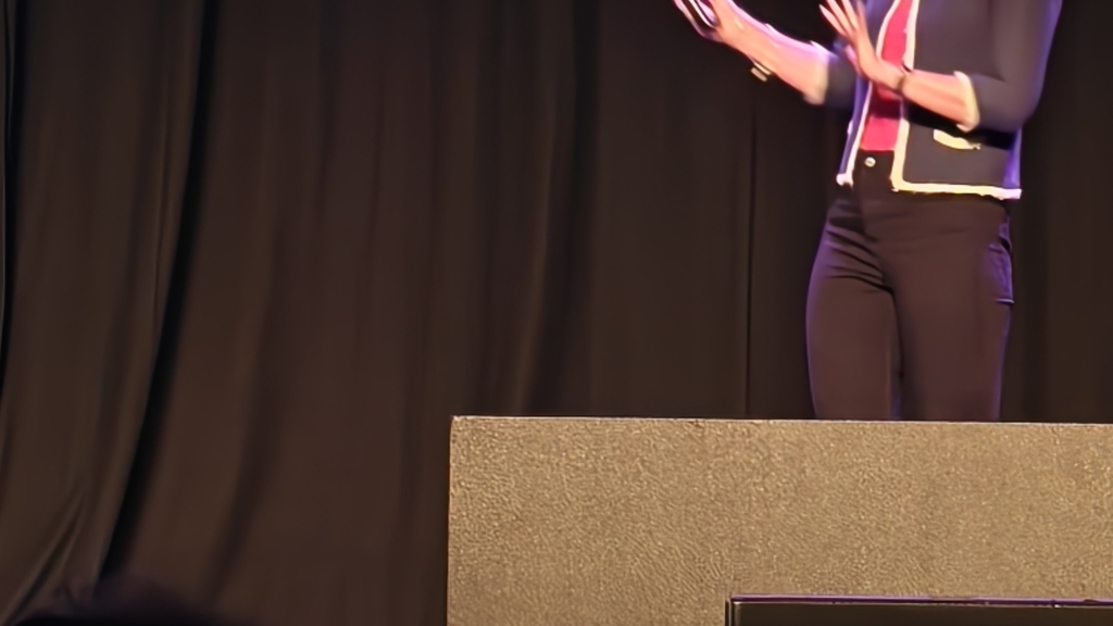 Suzanne on stage presenting image