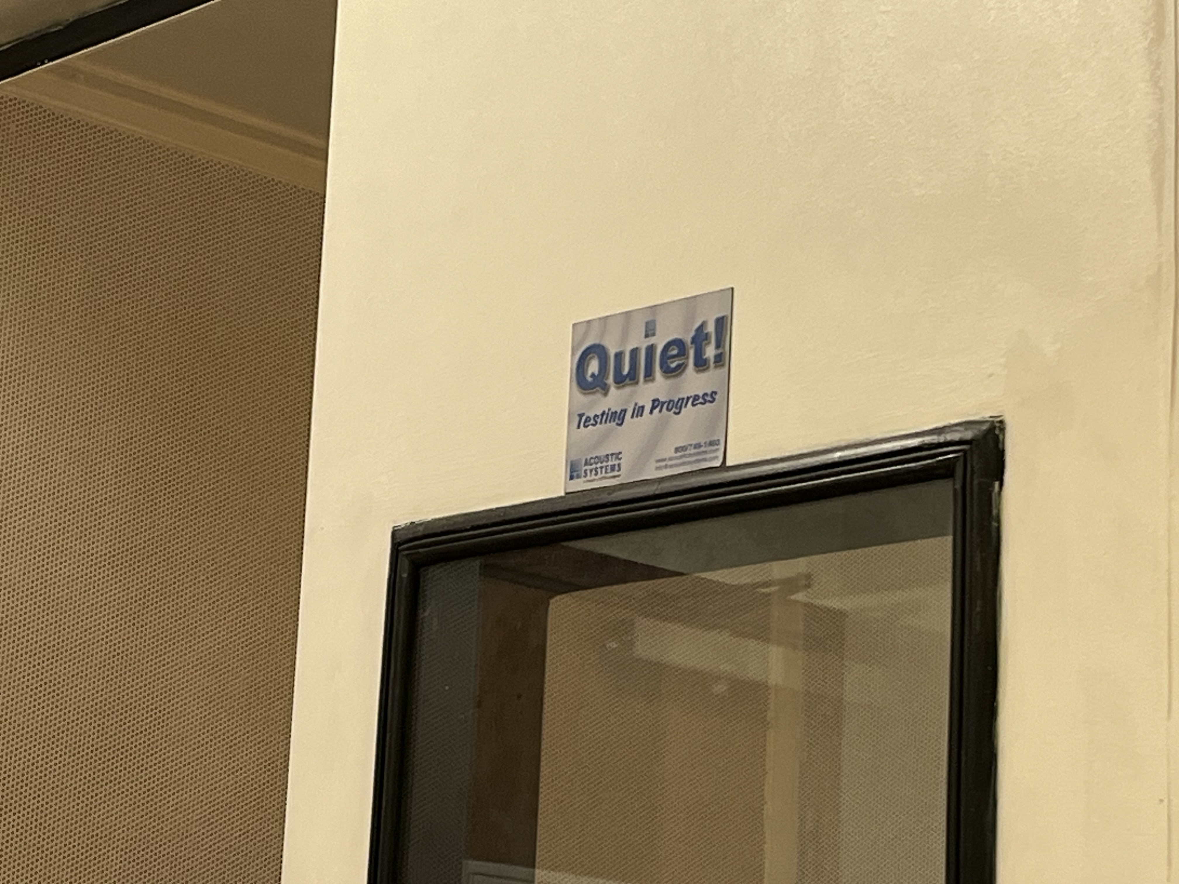 Signage reading "Quiet! Testing in Progress"