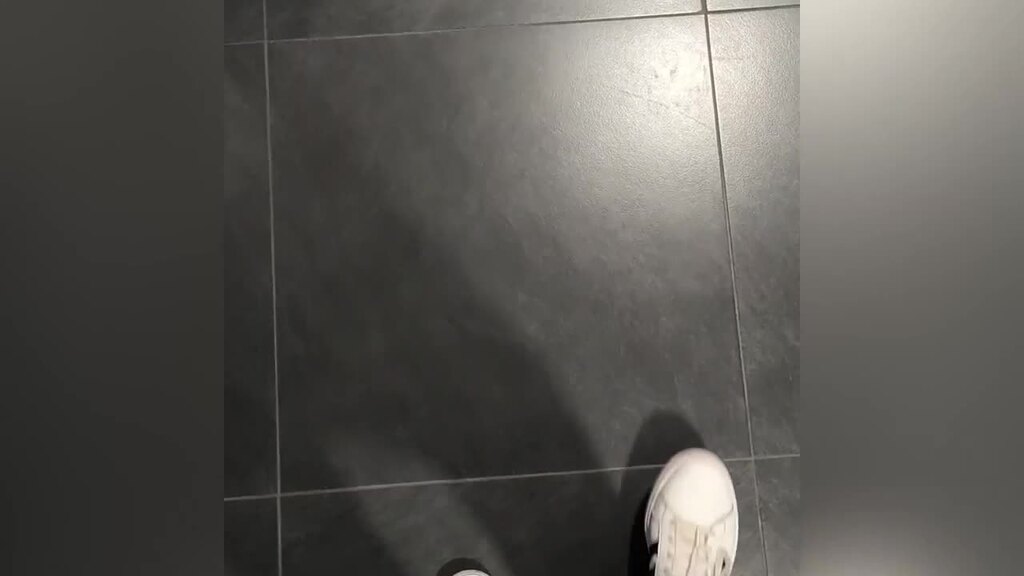 The video begins with a first-person perspective of someone walking into an office space. It features various shots o... image