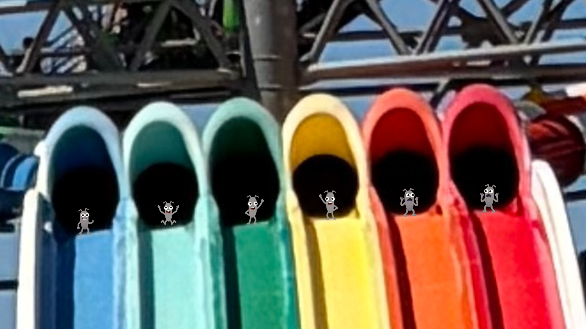 A row of six colourful, multi-lane water slide tunnels lined up side by side in rainbow order—blue, light blue, green... image
