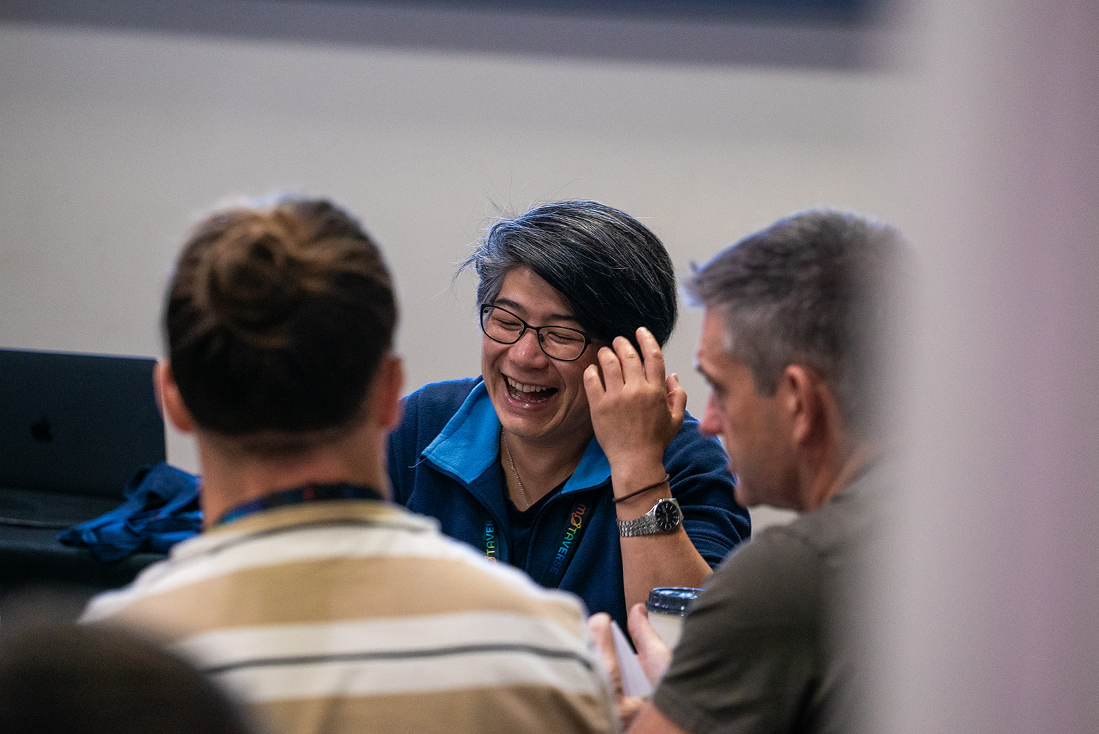 An attendee laughing around the table