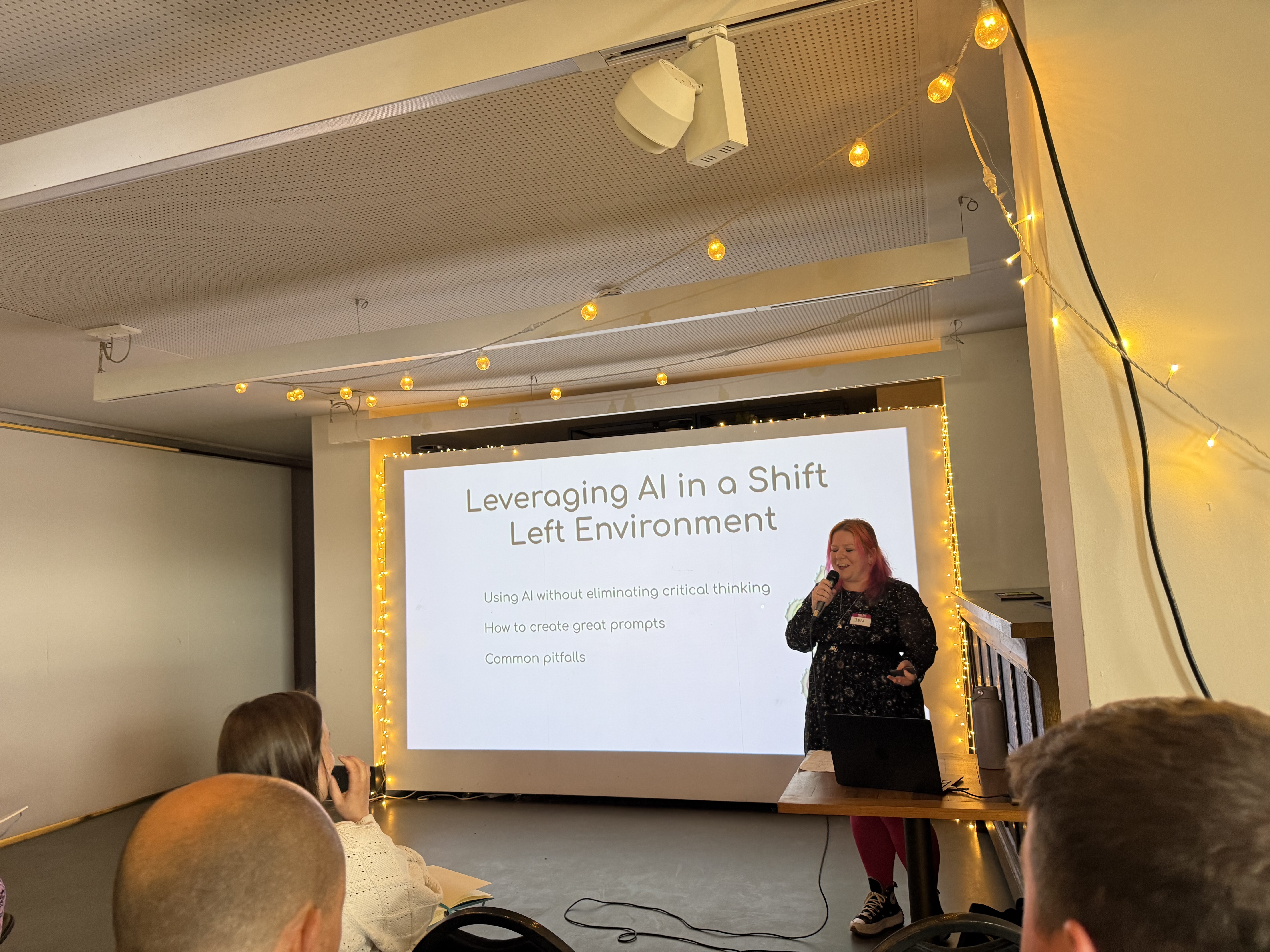 Jennifer speaking by a screen with Leveraging AI in a shift left environment and the points. Using AI without elimina... image