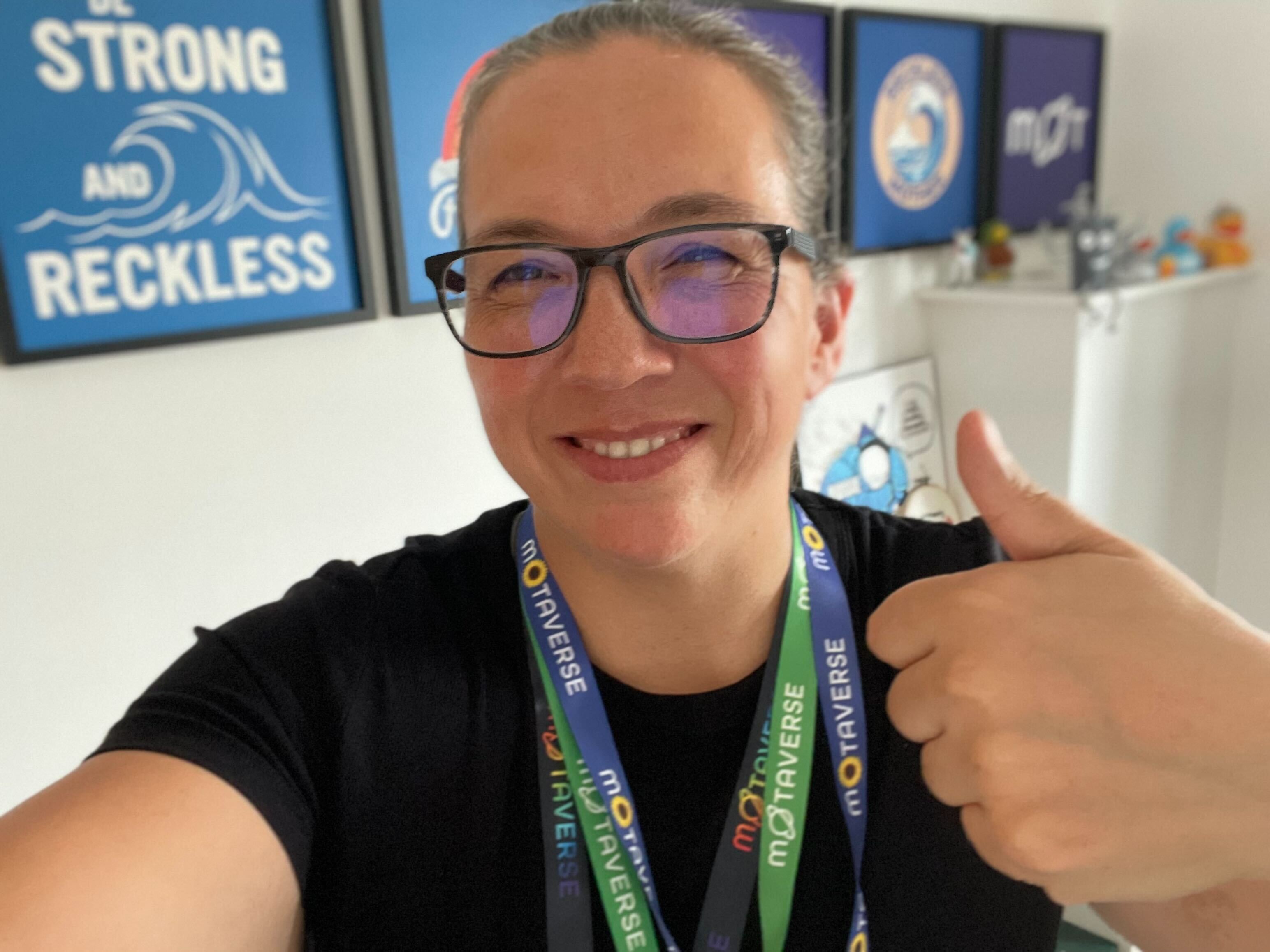 A selfie of Rosie wearing all three MoTaverse lanyards.