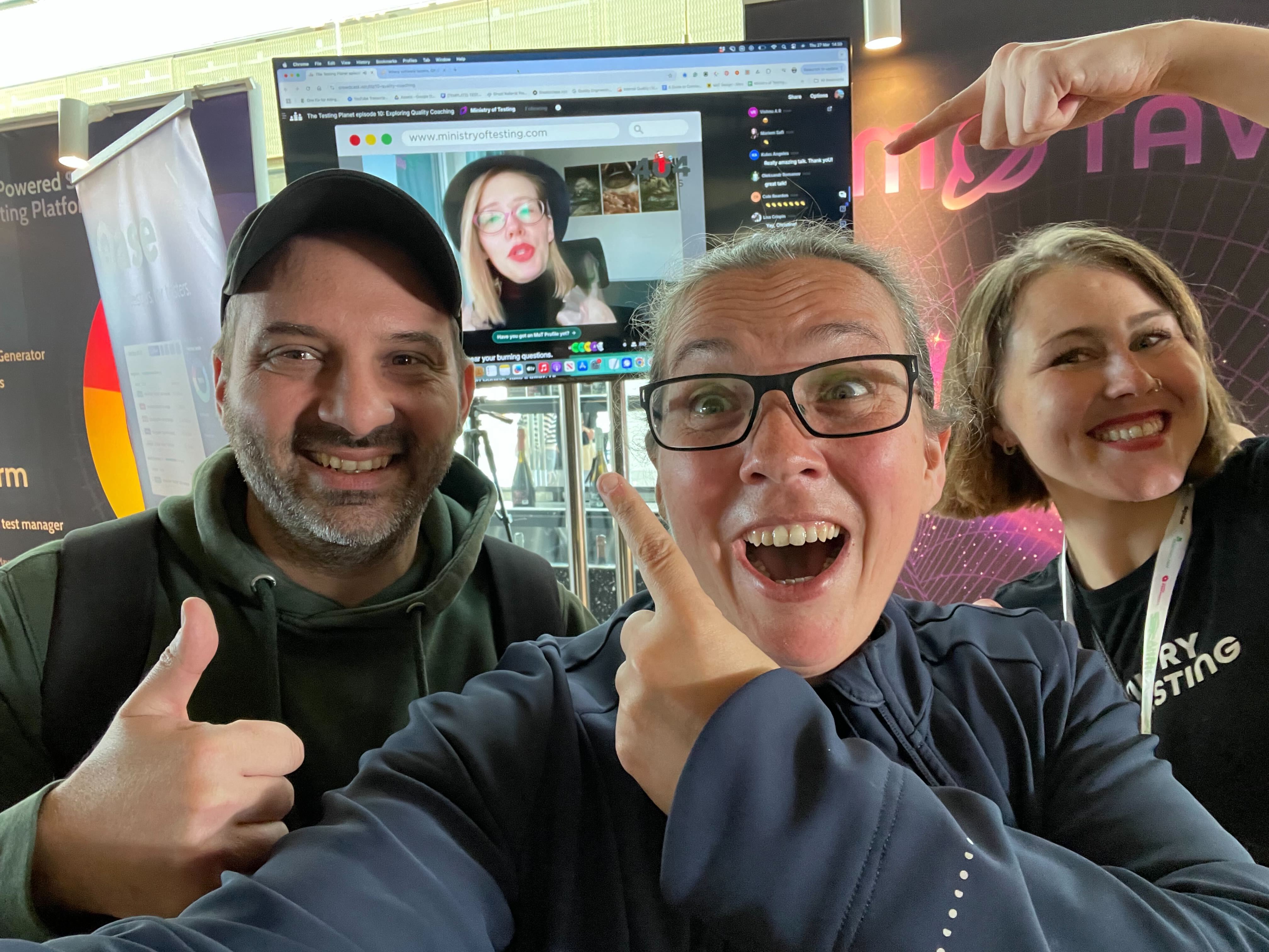 Petros Plakogiannis, Rosie Sherry and Alexanrda Cella taking a selfie with Christine in the background on a TB screen.