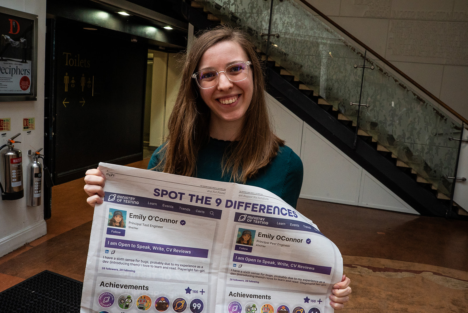 Emily O'Connor holds up the centre spread of The Testing Planet.