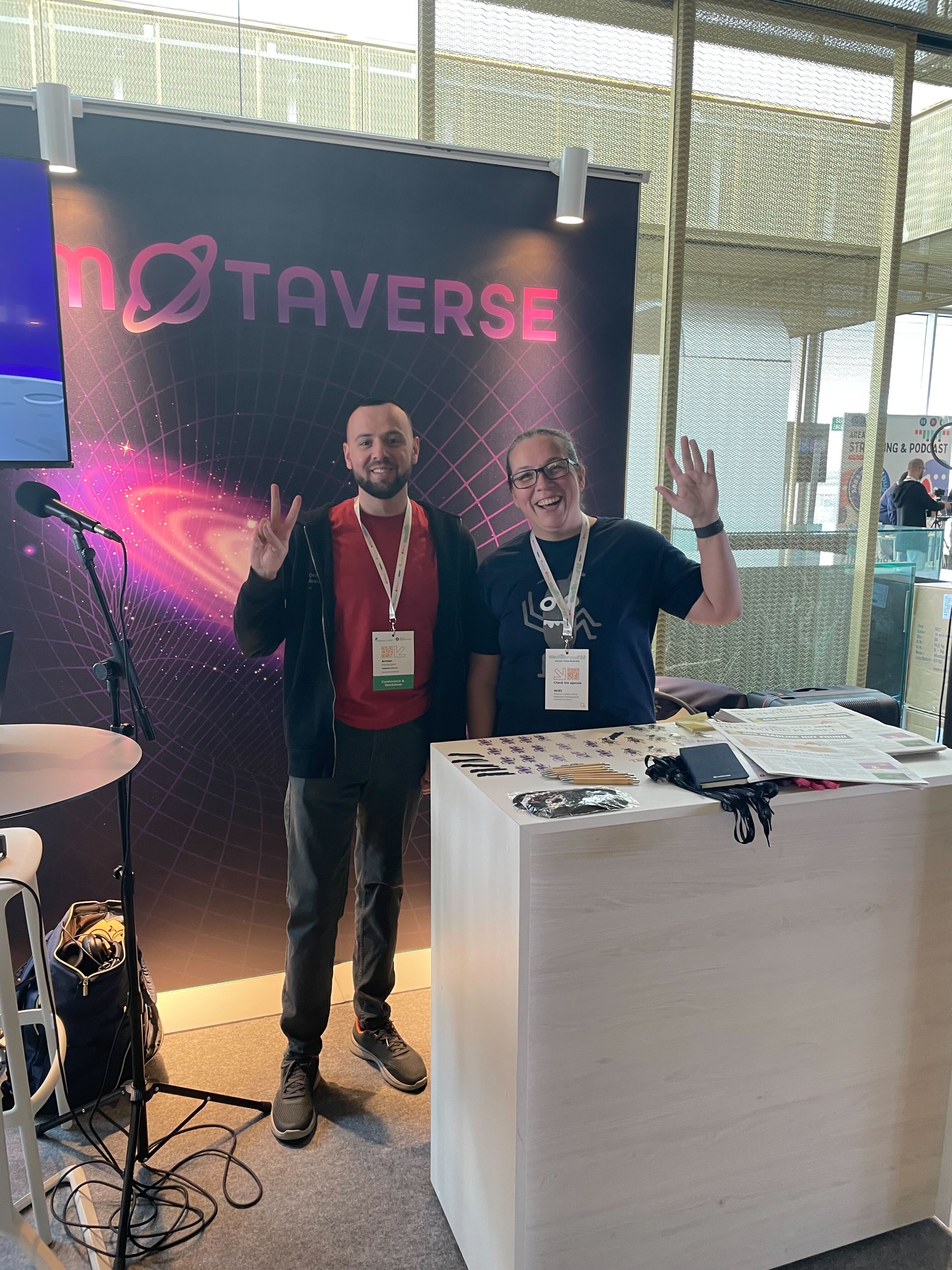 A photo of Arman and Rosie Sherry with the Ministry of Testing's MoTaverse stand in the background.