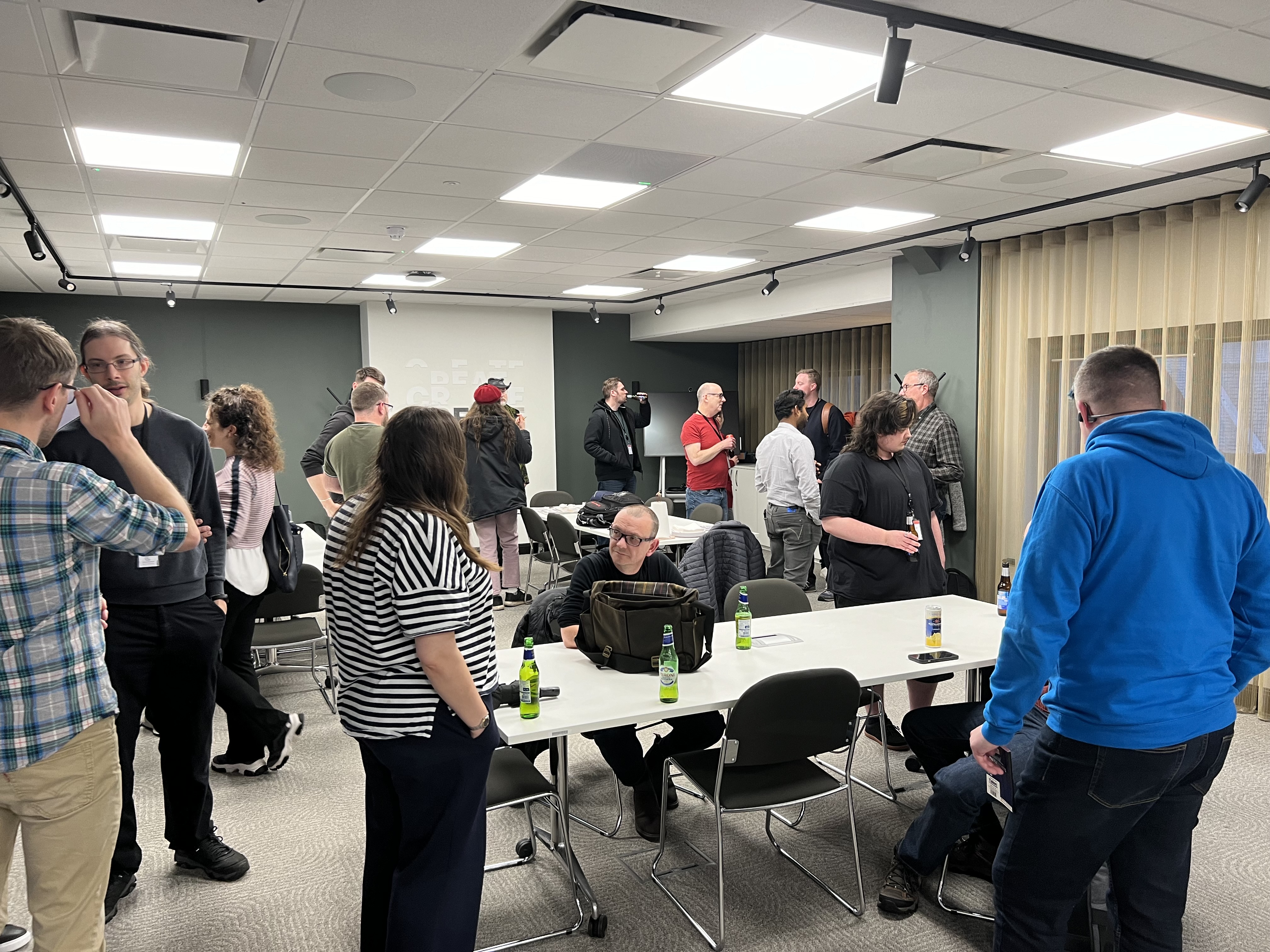 Attendees networking before the talks and pizza 