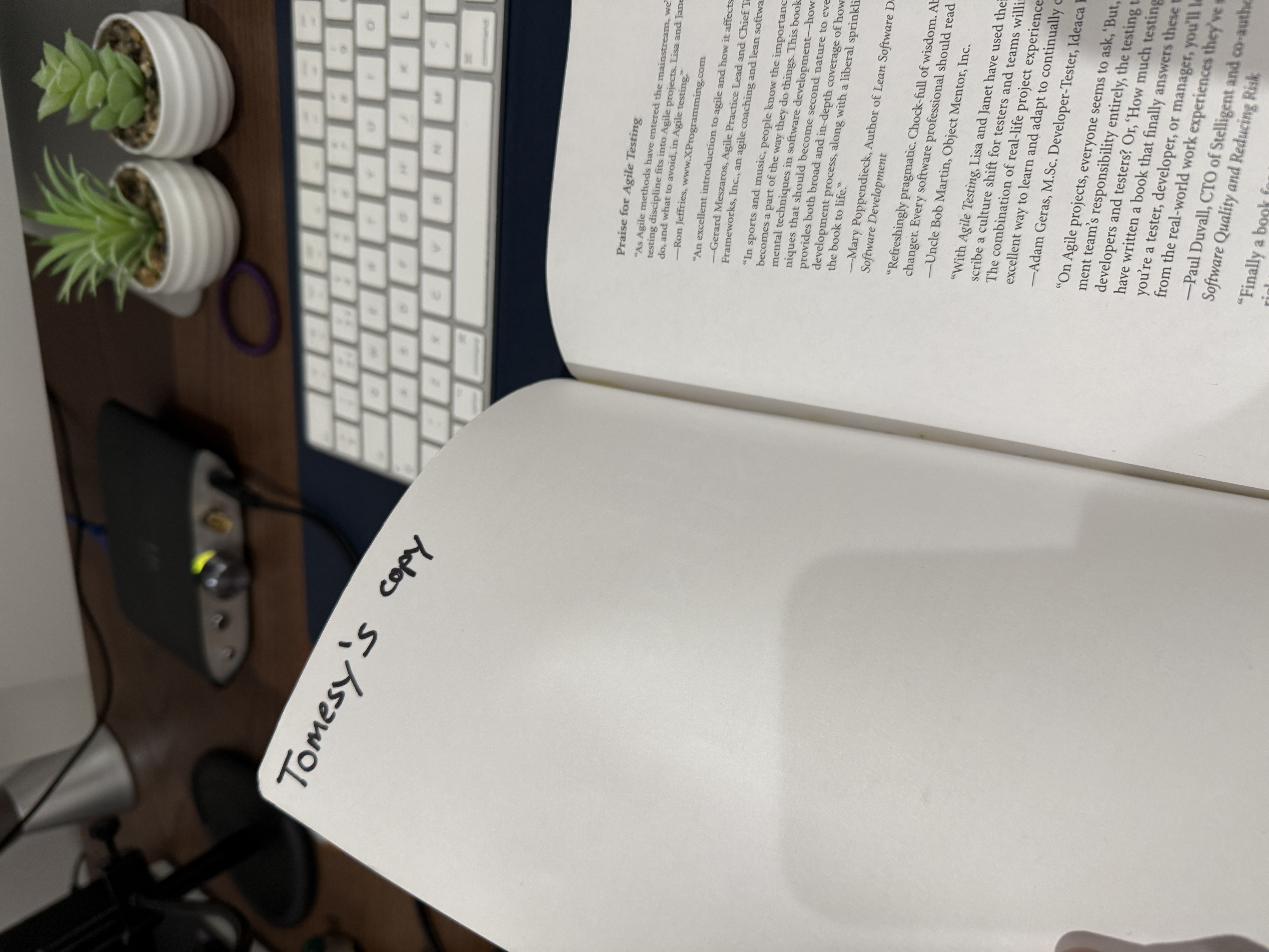 Photo of a 1st edition Agile Testing book by Lisa Crispin and Janet Gregory. It has "Tomesy's copy" written in the to... image