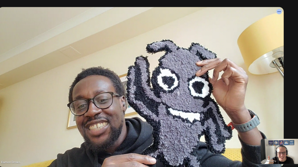 A screenshot of a virtual conversation with Eamon holding up Bug Rug.