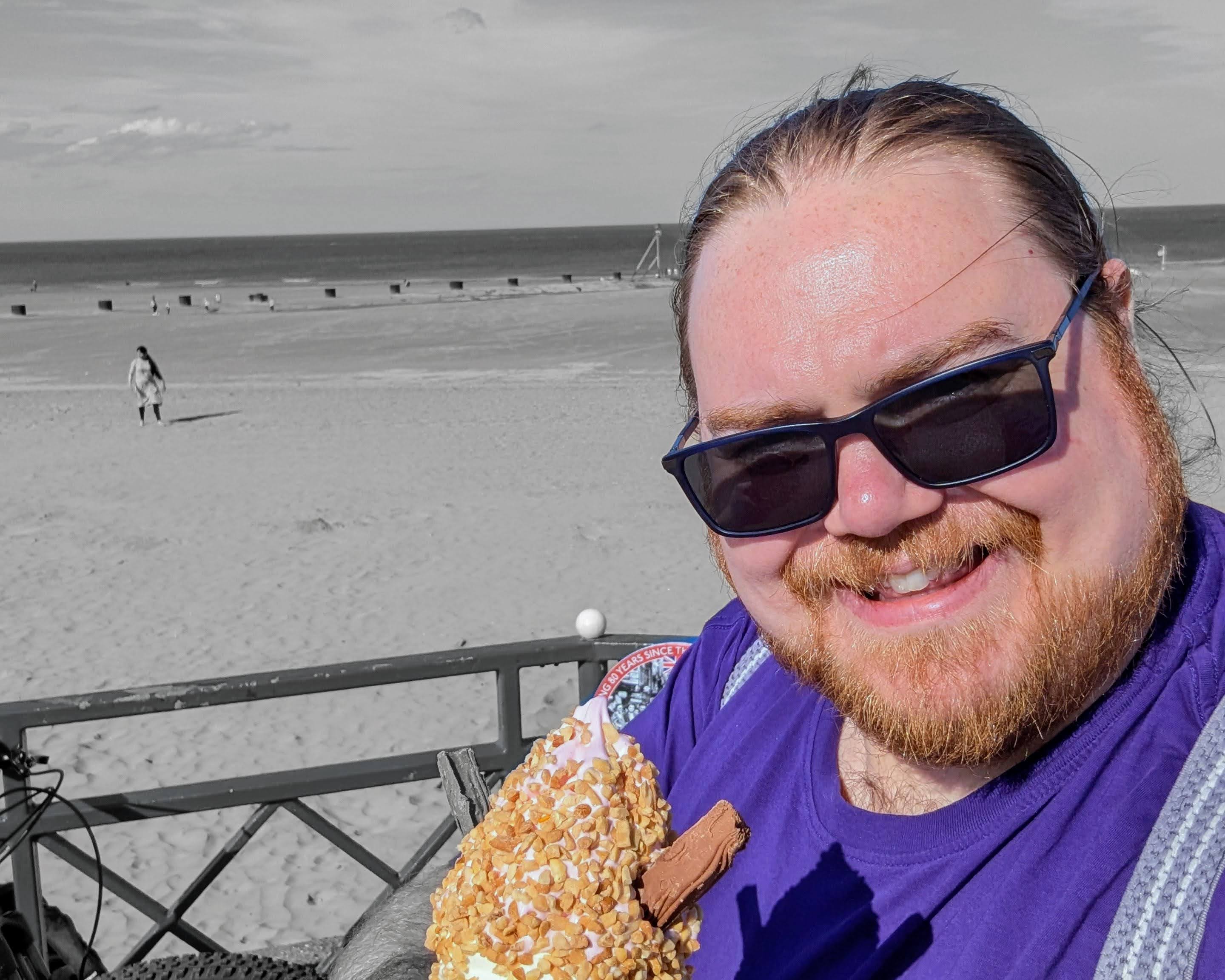 Photo of Ben, a white male with ginger hair, eating an ice cream, stylised with colour pop