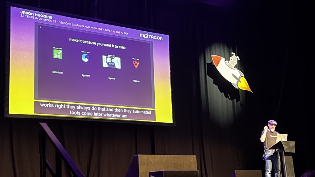 Jason on stage, the screen behind him shows a slide titled “make it because you want it to exist,” featuring logos fo... image