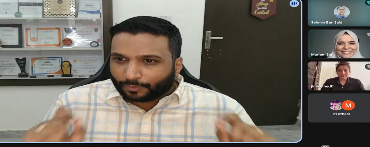 A screenshot from a virtual conference session featuring Rahul Parwal as the main speaker, actively gesturing while presenting. Behind him is a display shelf filled with certificates and awards. The right side of the screen shows participant video tiles, including Selmen Ben Said, Mariem Safi, Jinene Hedfi, and a tile indicating "21 others" attending. The setting appears to be a professional meetup, possibly part of the MoT Sousse community event.