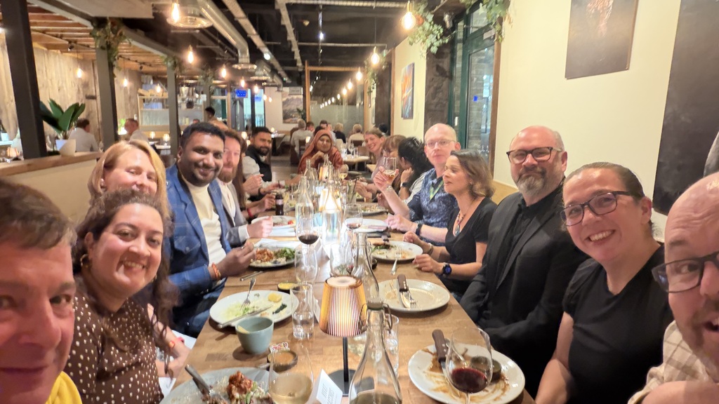 People sitting at a dining table in a restaurant. image