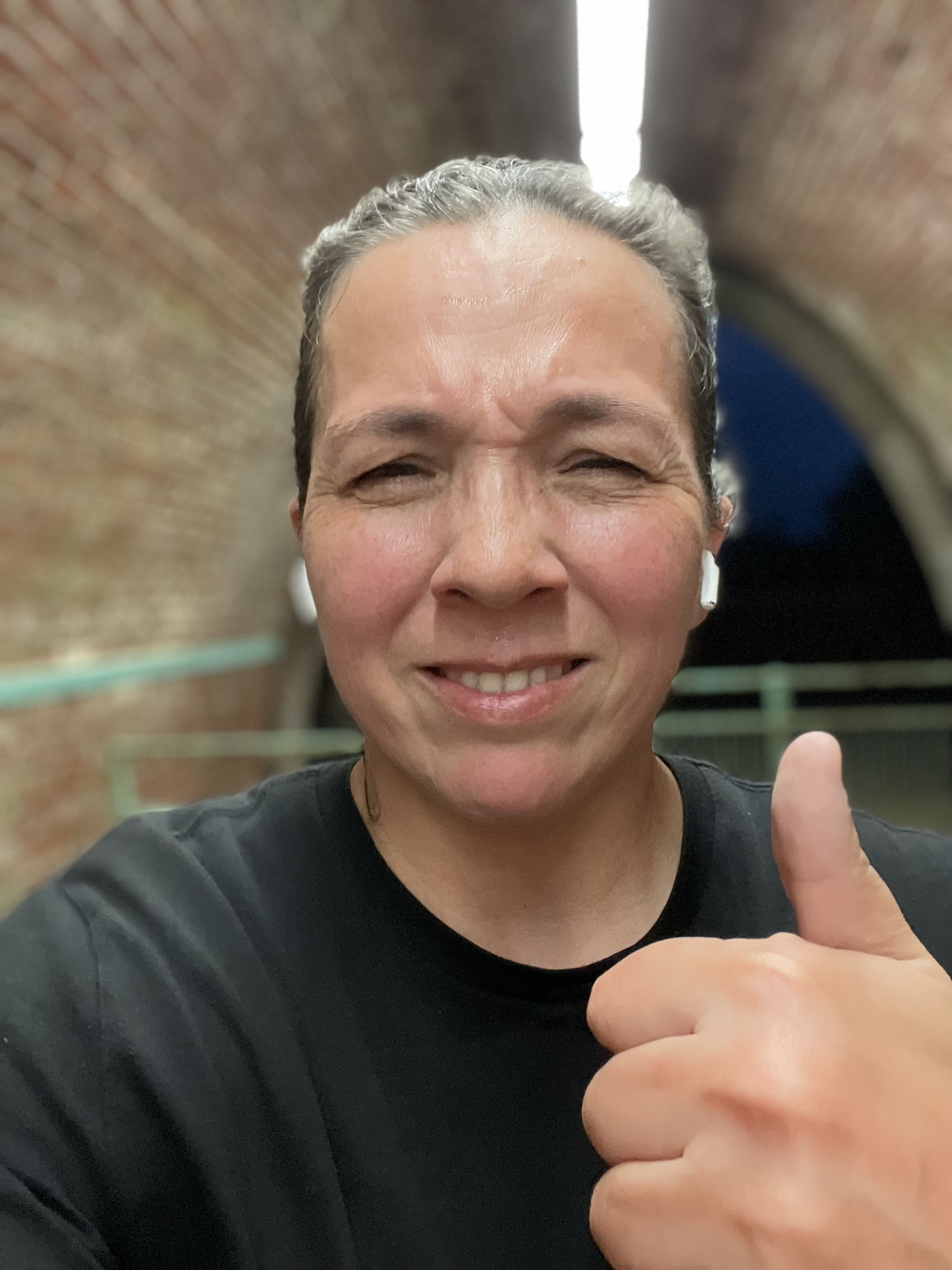 Selfie of Rosie after a run with her thumbs up.