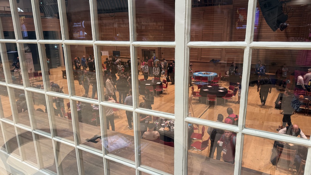 View from the second floor overlooking the corn exchange with the sponsor tables below. The view is through smaller w... image