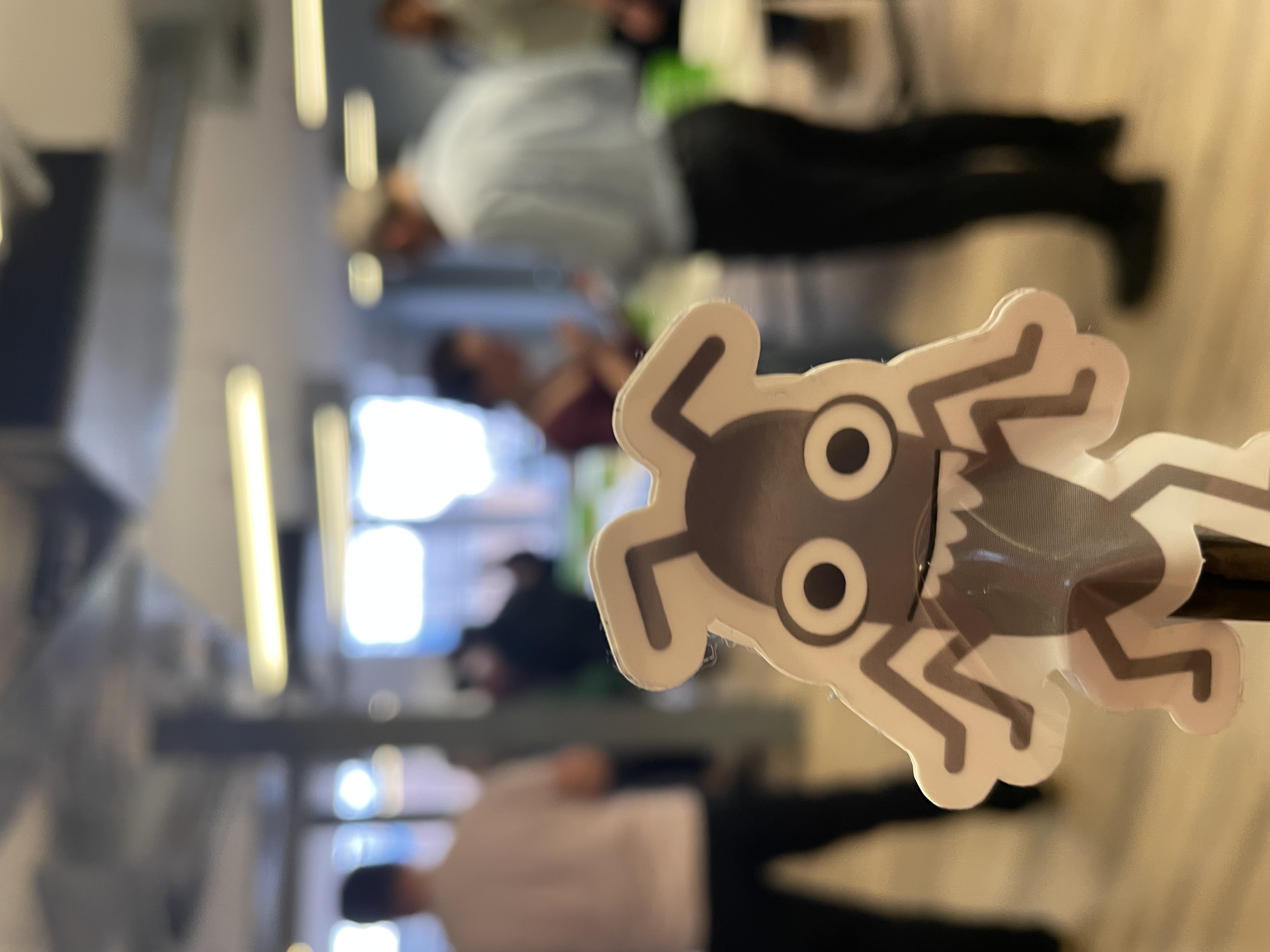 A photo of bug looking towards a background of people socialising at MoT London.