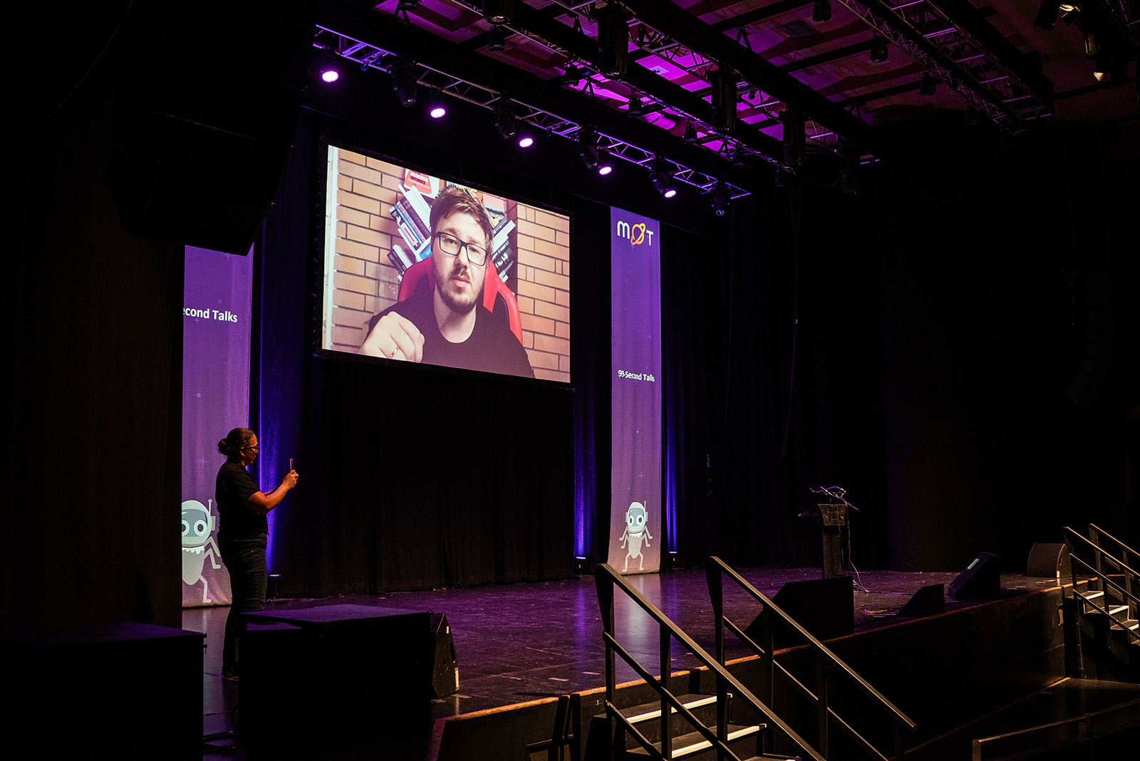 Olekasandr on the big screen with a pre-recorded talk.