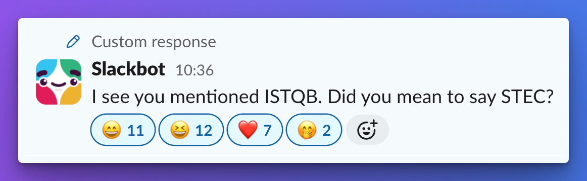 A humorous custom Slackbot message in Slack reads: "I see you mentioned ISTQB. Did you mean to say STEC?" The message has received multiple emoji reactions below it: 😁 (11), 😂 (12), ❤️ (7), 🤭 (2), and a custom emoji with a smiling face. The background gradient is a blend of purple and blue tones.








