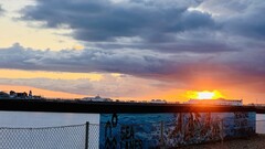 The sun setting behind Brighton pier with storm clouds building over Brighton. image