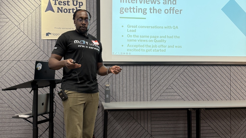 Eamon wearing an MoT black London tshirt presenting with a slide showing interviews and getting the offer. After great conversation he was eager to get started. But the interviewer left before he started! 