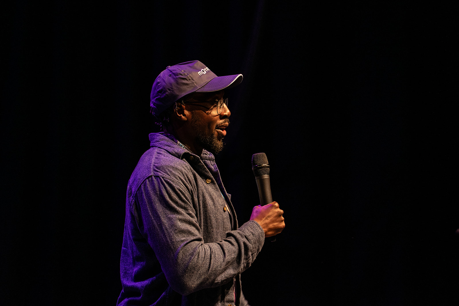 Eamon Droko on the MoTaCon stage with a MoTaverse cap