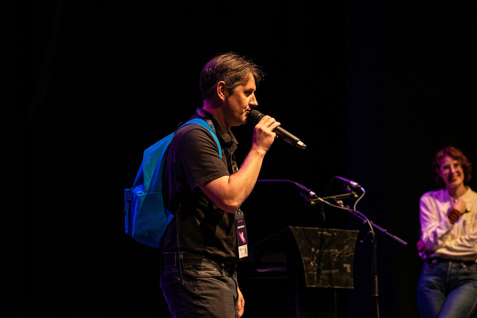 Andrew Morton on stage with lovely blue MoT ruck sack