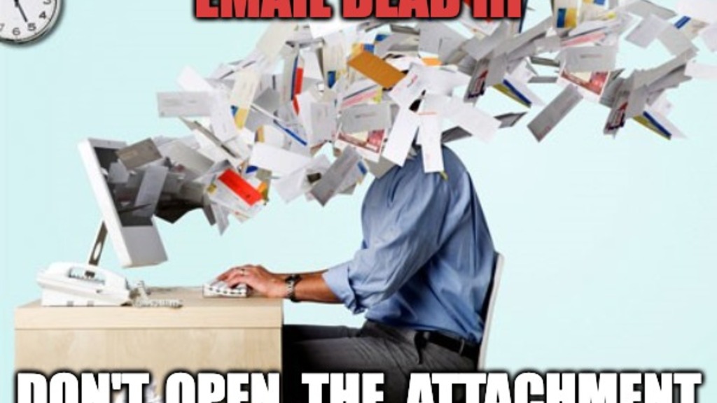 A man sitting at his desk has hundreds of pieces of paper streaming from the screen into his face. The wording says, Email Dead III. Don't open the attachment. 