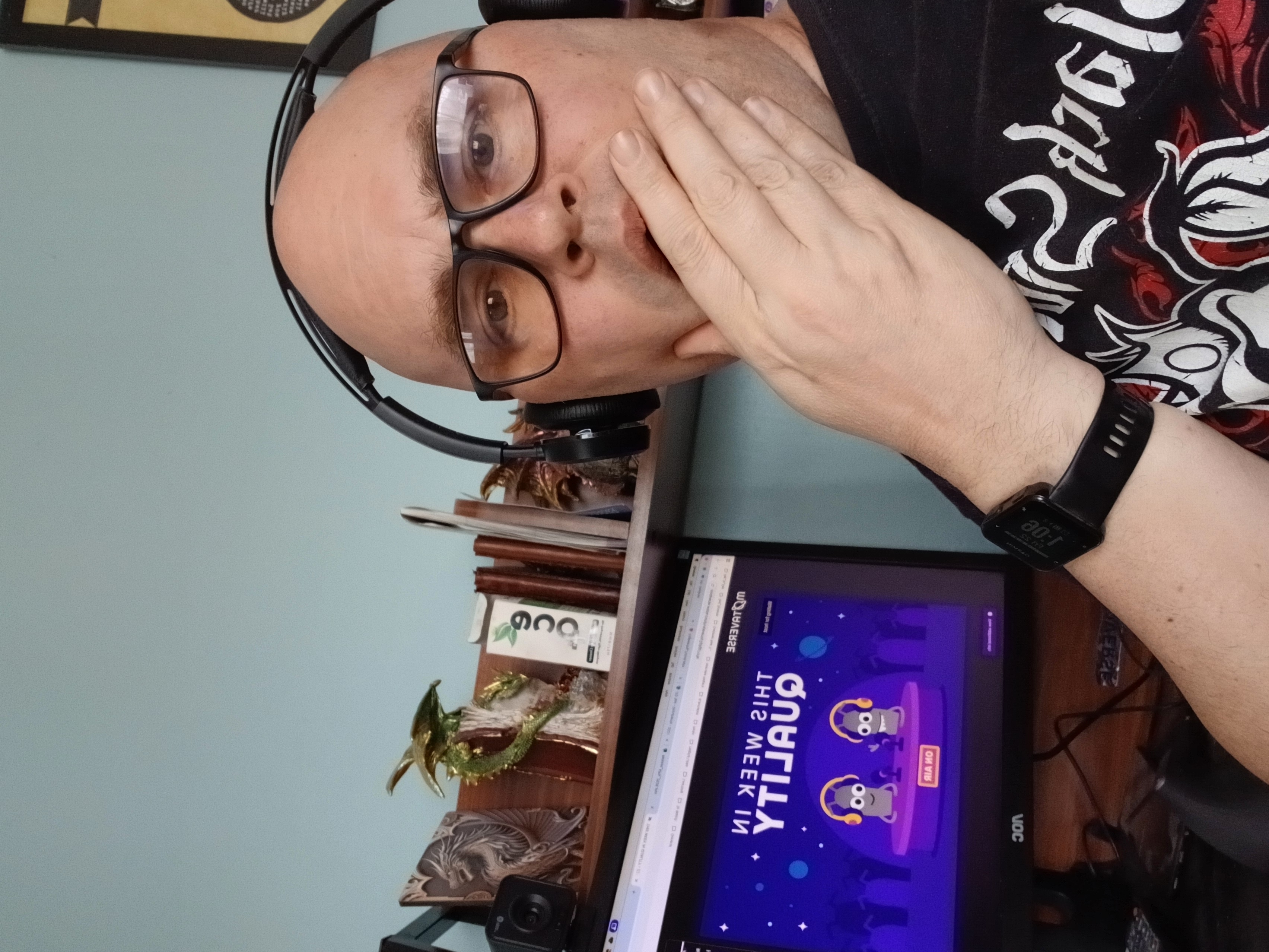 Selfie of Gary Hawkes in shock listening to TWIQ episode with the TWIQ on screen behind him image