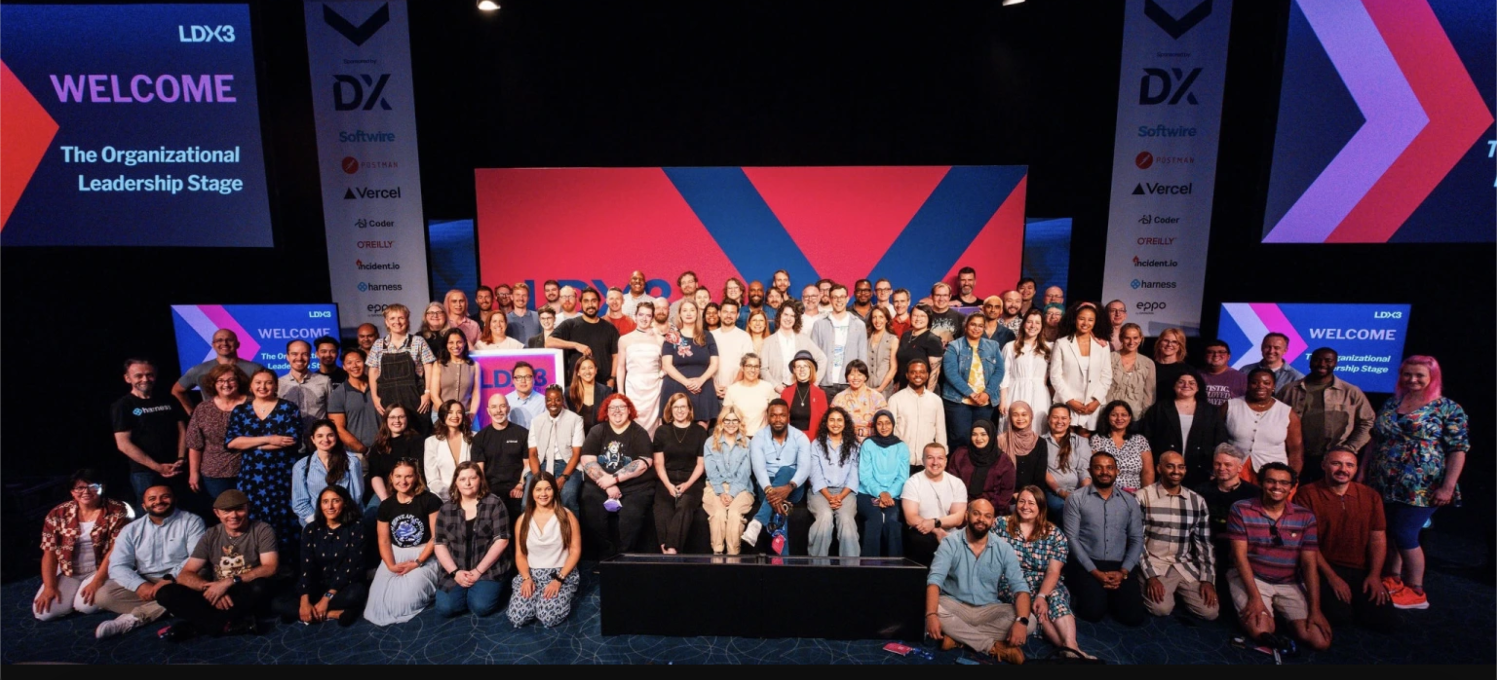 Picture from the London Festival of Engineering Leadership 2025, aka LeadDev3x. Christine is in red jacket centre stage surrounded by other people who are in leadership.