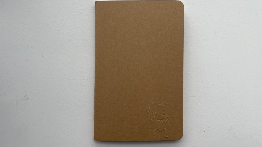 A photo of a notebook with Bug imprinted into it.