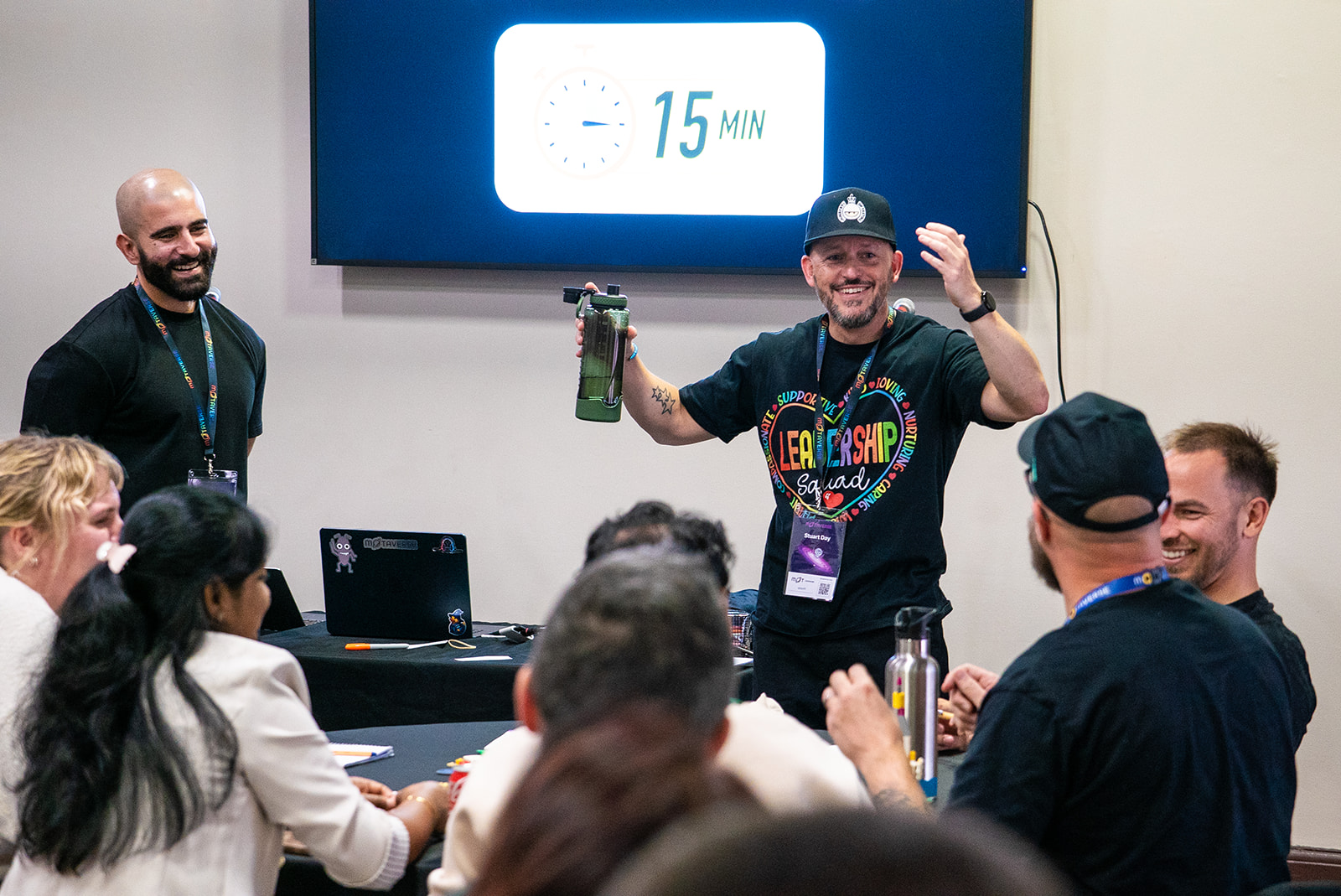 David and Stu laughing up at the fron of a room.