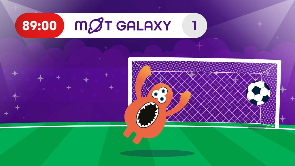 A colorful cartoon image shows a soccer field at night, with a goal in the background. An orange, blob-like cartoon creature with multiple eyes and a large, open mouth is in front of the goal, its arms raised in celebration. A soccer ball is shown just past the goal line, indicating a goal has been scored. Above the field, a scoreboard displays "89:00" on a red background and "M@T GALAXY" next to the number "1" on a white background. The background is a dark purple sky with sparkling stars.