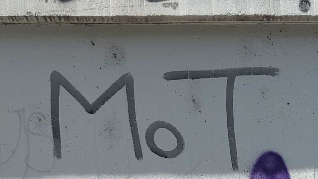 'MoT' graffiti tag on a wall in Leipzig, Germany