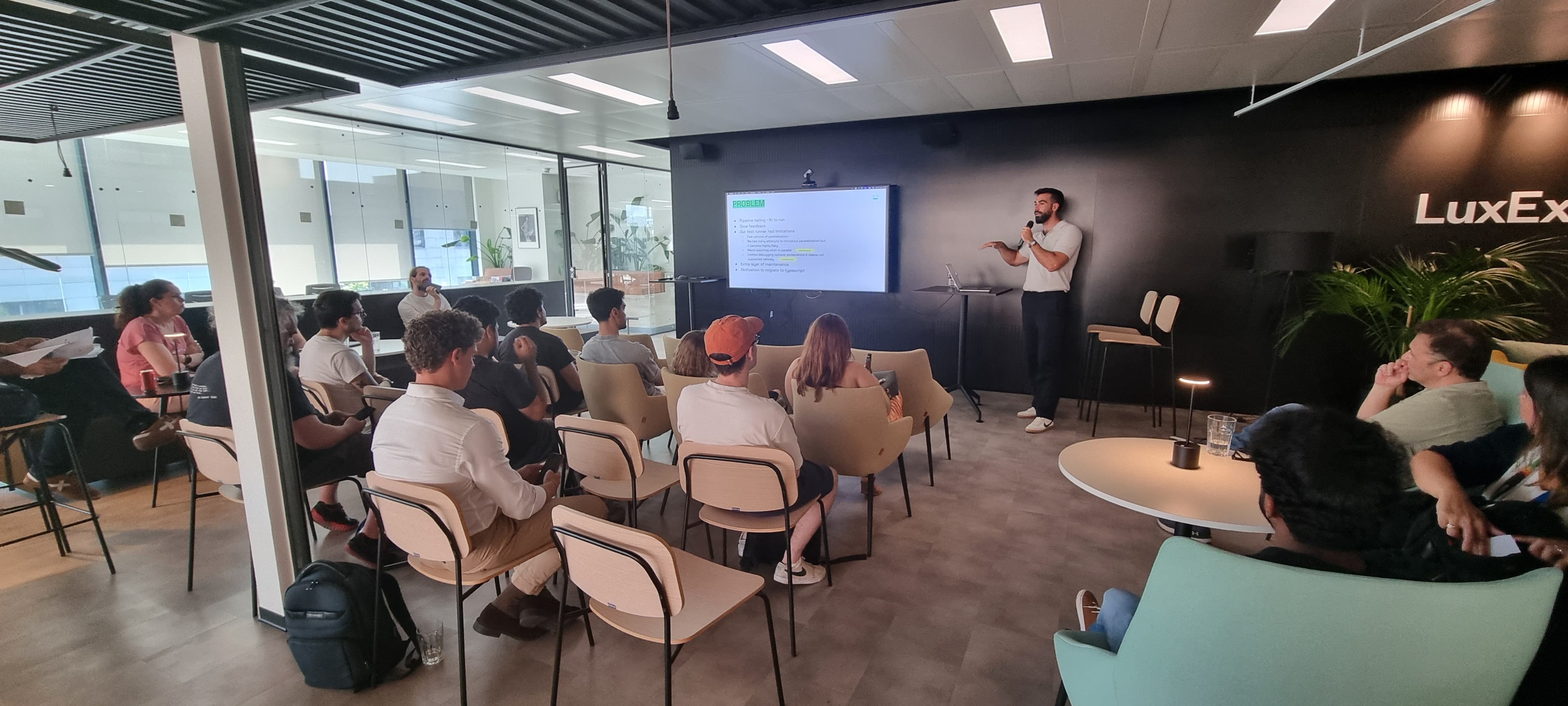 Luis giving a presentation to a crowd of testers