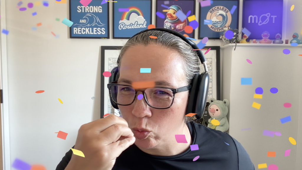 Rosie is reenacting a chef's kiss with digital confetti dropping down around her image