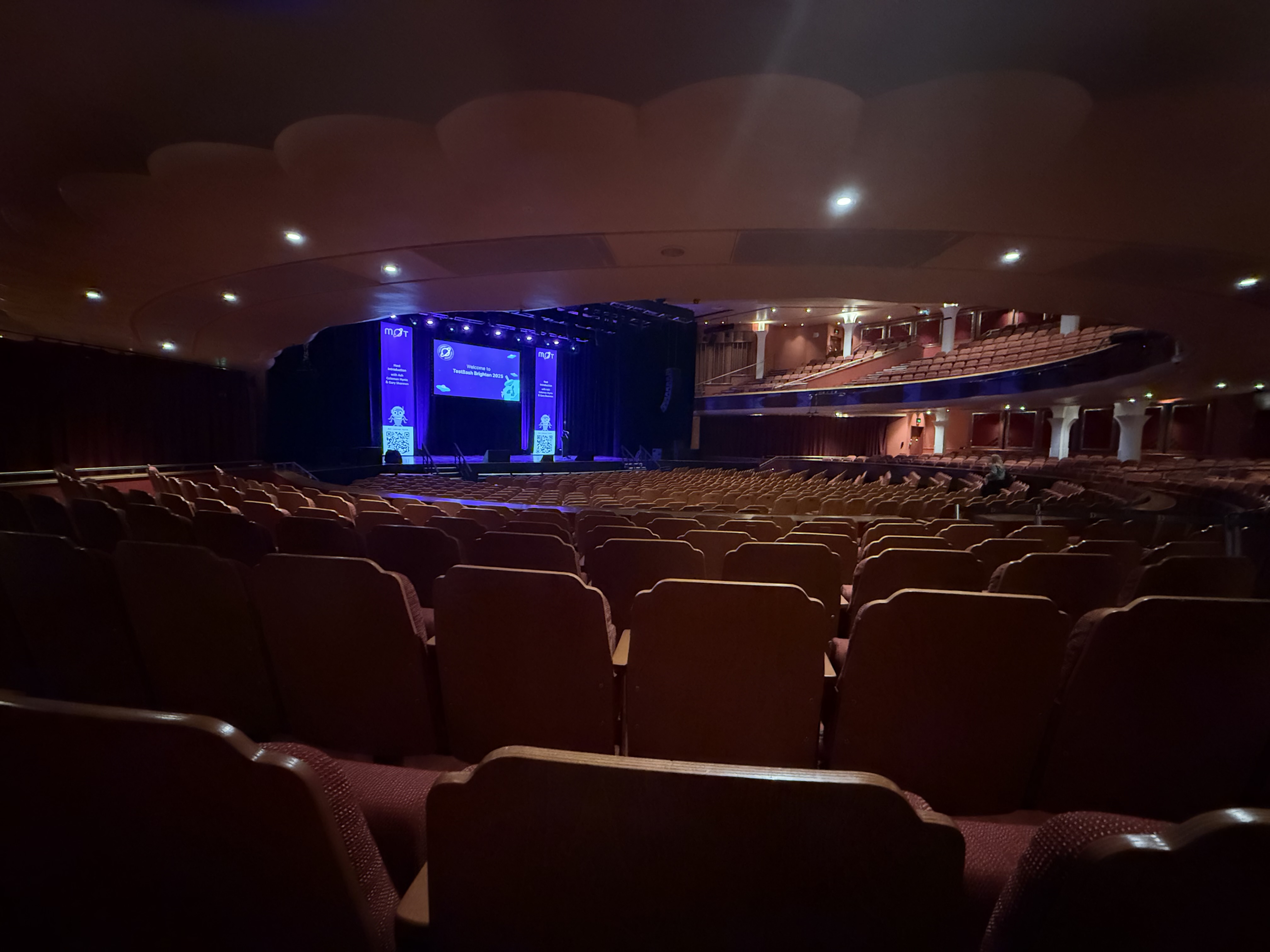 The main stage of the Brighton Dome with long banners either side and welcome to TestBash Brighton on the centre display 