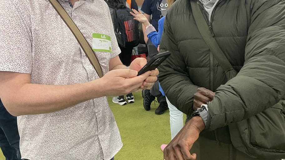 Eamon Droko and Chris Pratt testing out the watch QR code connection thing image